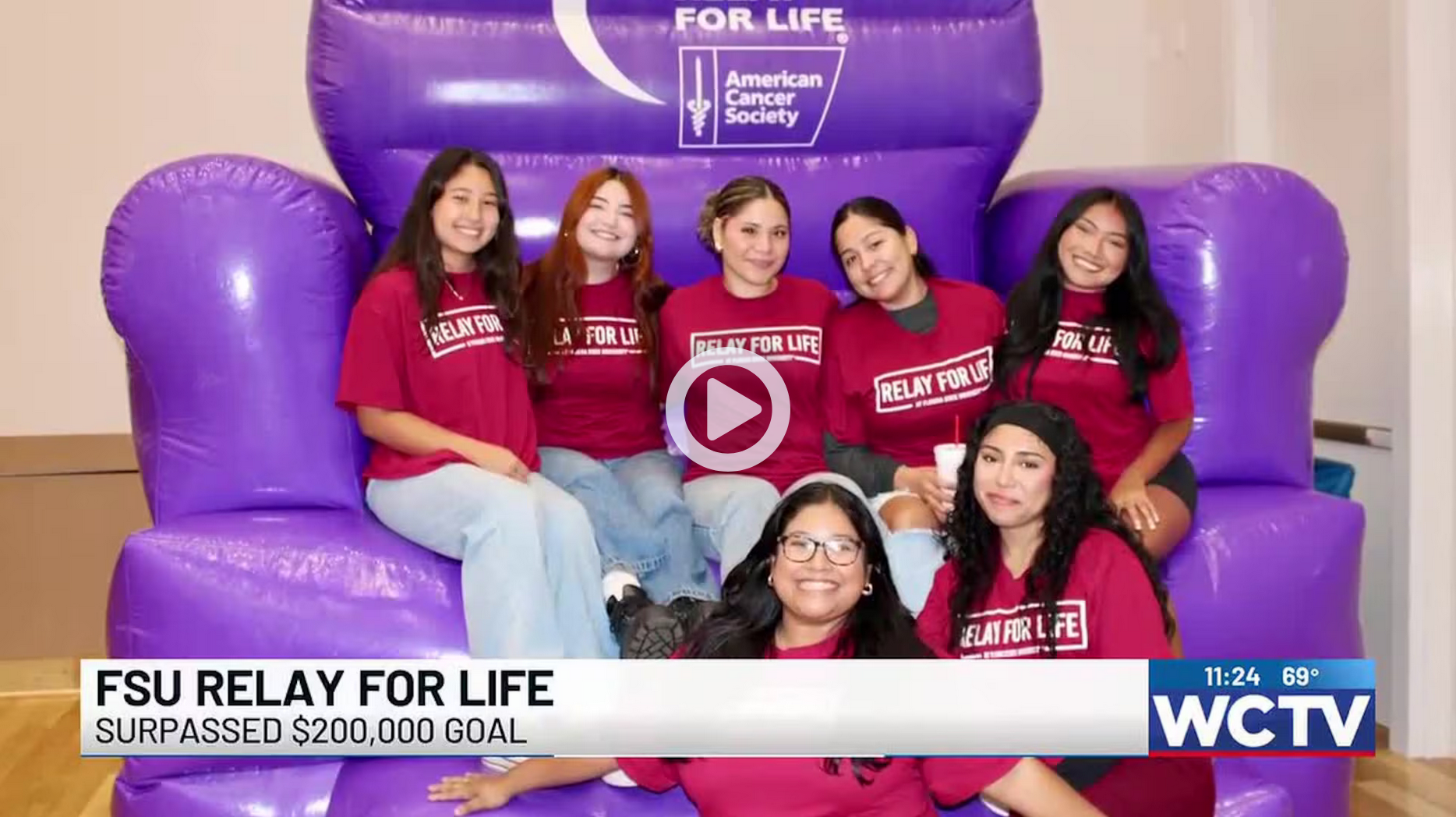 students sitting on a purple blowup relay for life branded couch