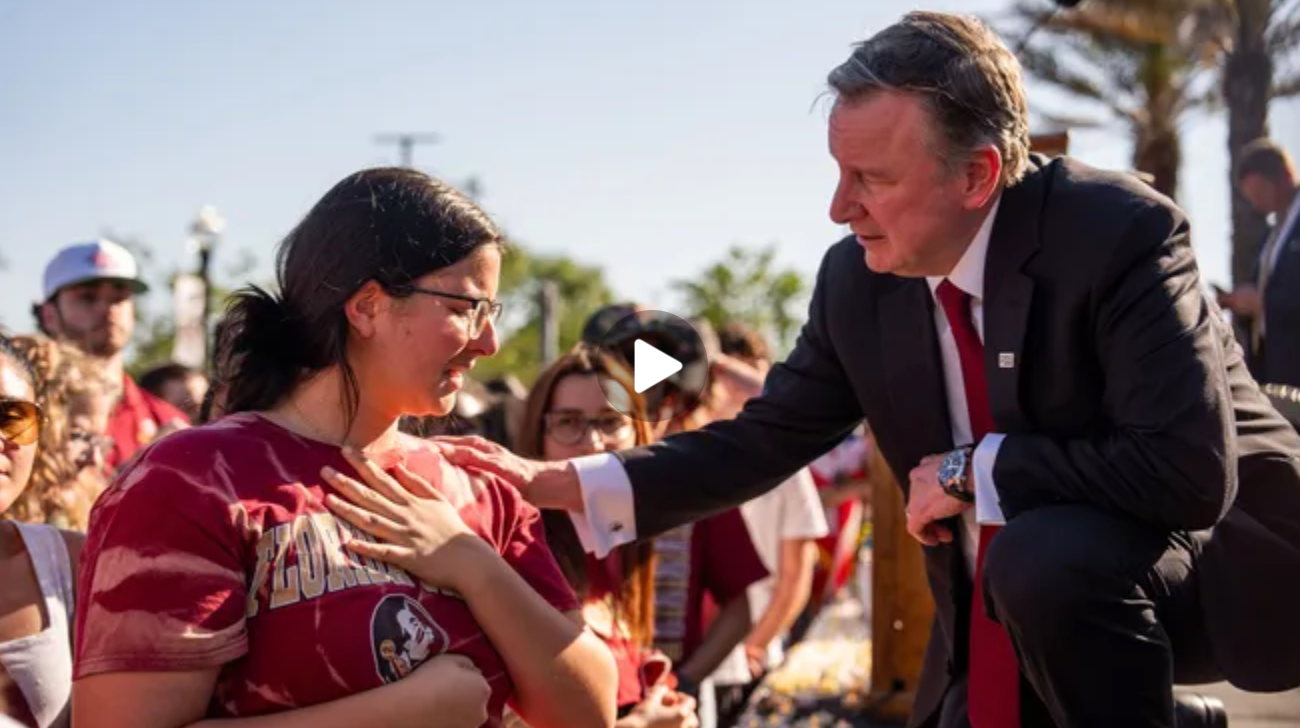 FSU President Richard McCullogh offers a steadying hand on the shoulder of an FSU student overcome with emotion