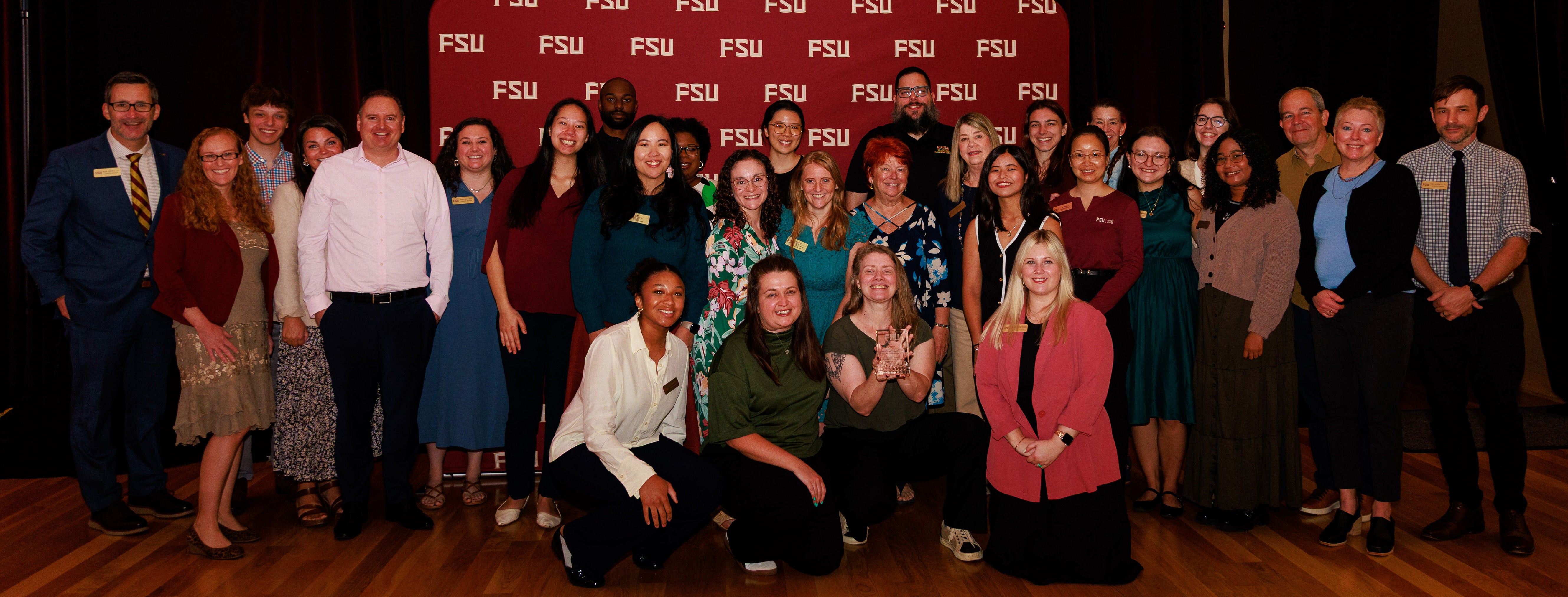 40 people smiling in a group from the career center