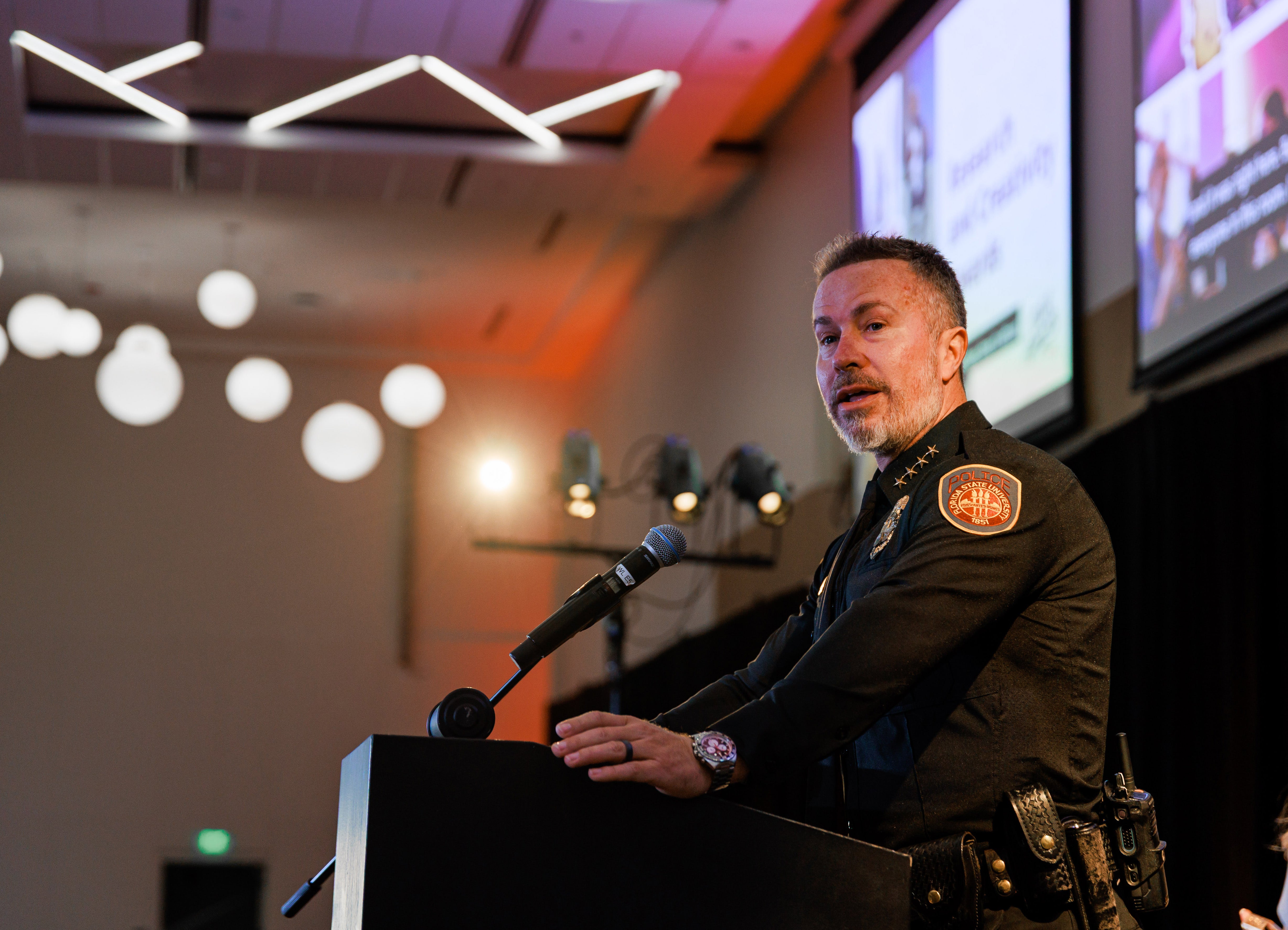 Police Chief Trumbower accepting award for Barbara O'Connor