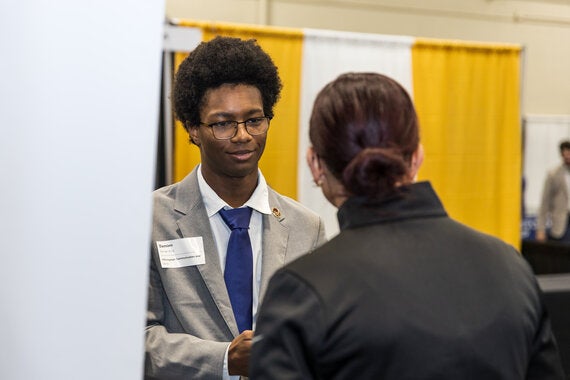student shaking employer's hand