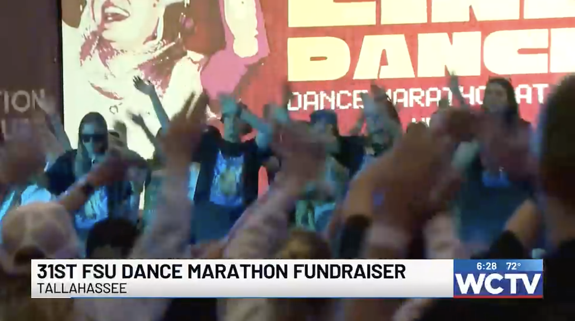 Students throwing their hands in the air and dancing 