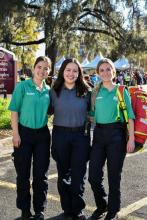 three medical response unit students pose in front of an FSU sign