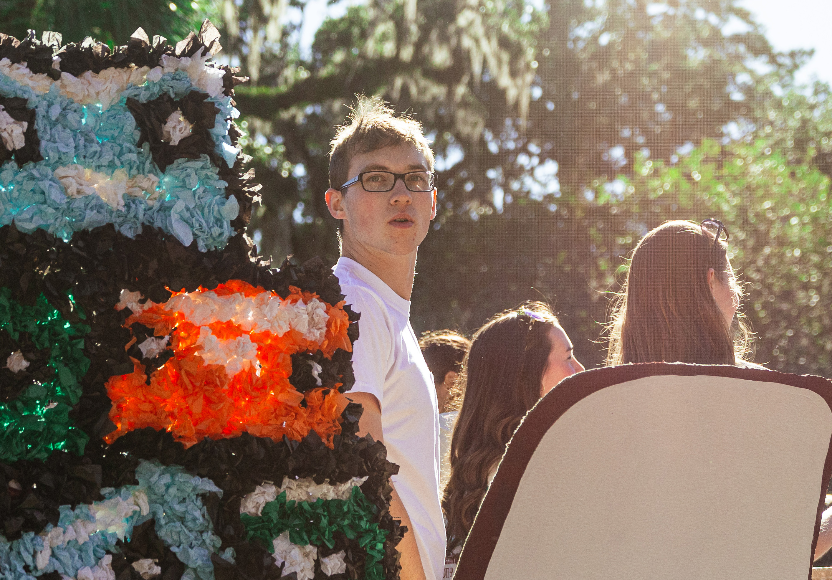 student looking back with sunlight behind him