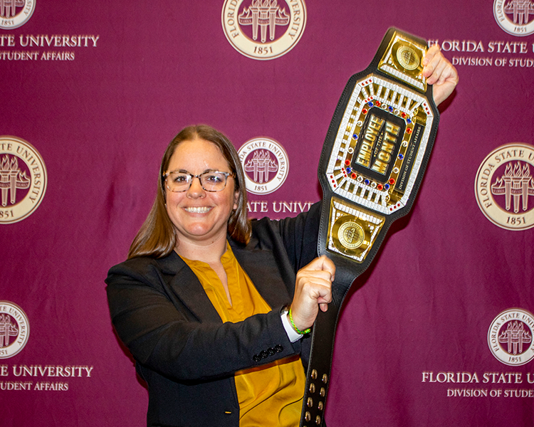 Amy Haggard holding Employee of the Month belt