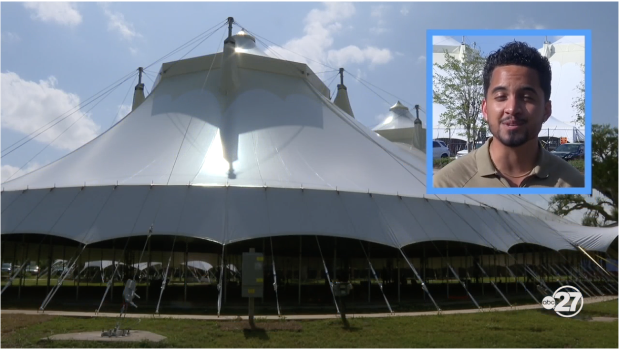 News anchor Alberto Camargo framed in the corner of a shot of the FSU circus big top