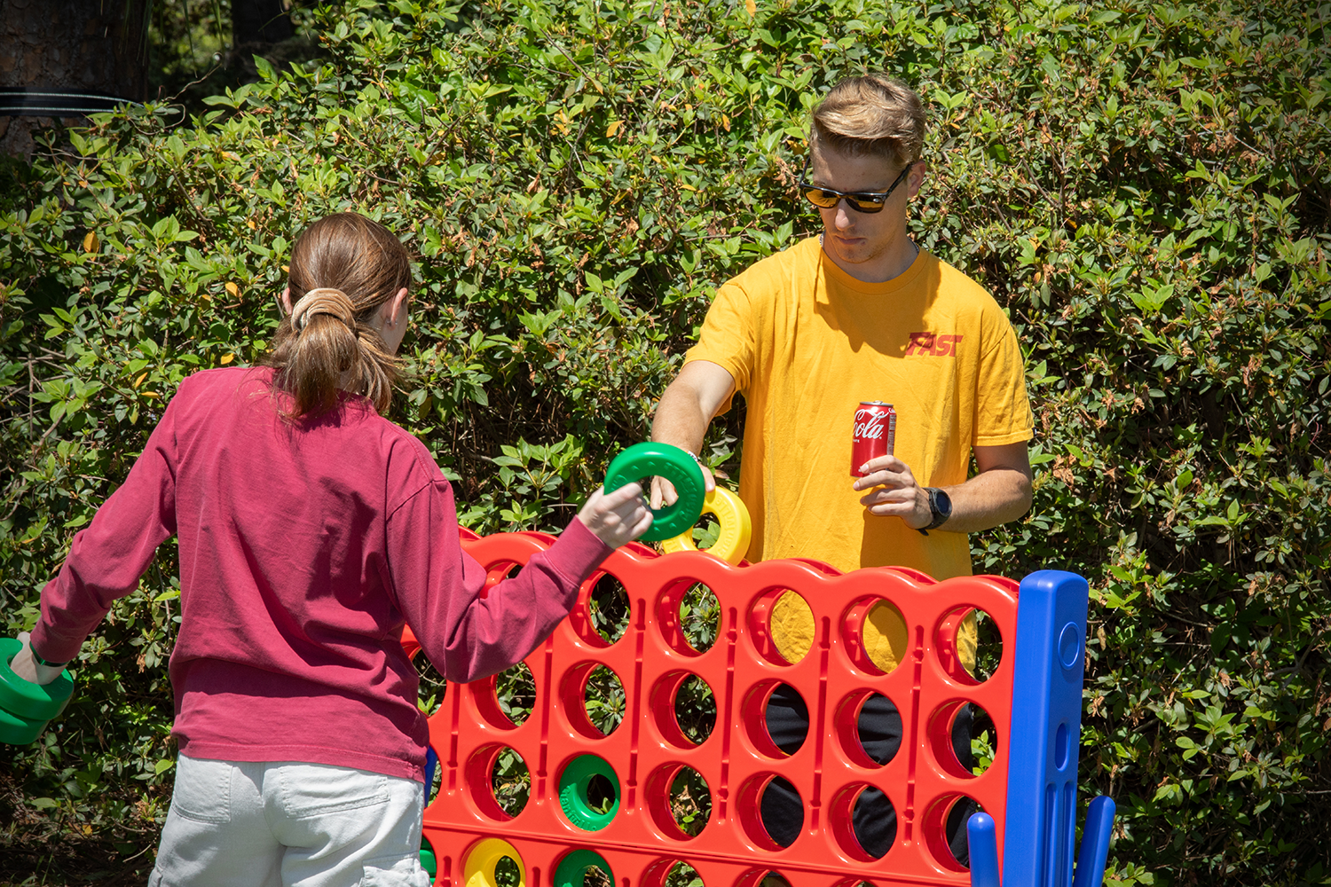 students playing an extra-large lawn version of connect four