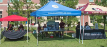 tents for student safety events erected on a green lawn